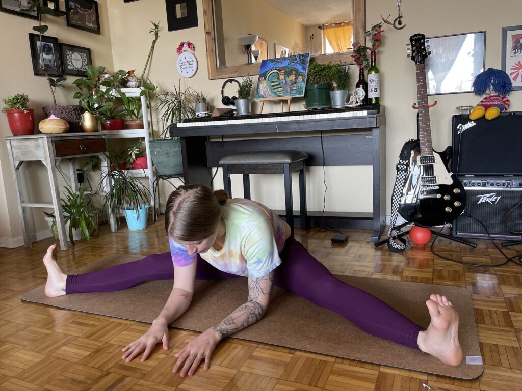 girl doing seated wide legged forward foldduring yoga