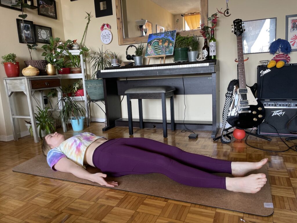 girl doing corpse pose during yoga