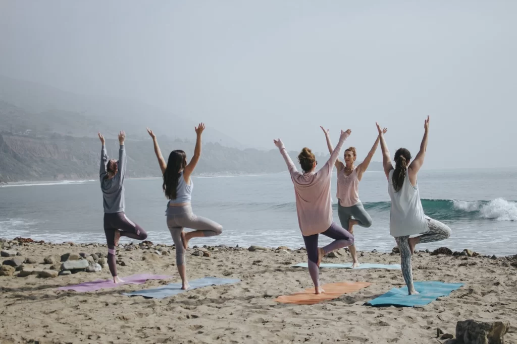 Group yoga class on the beach