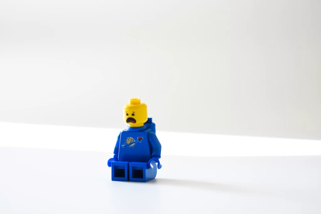 blue lego minifig on white surface
